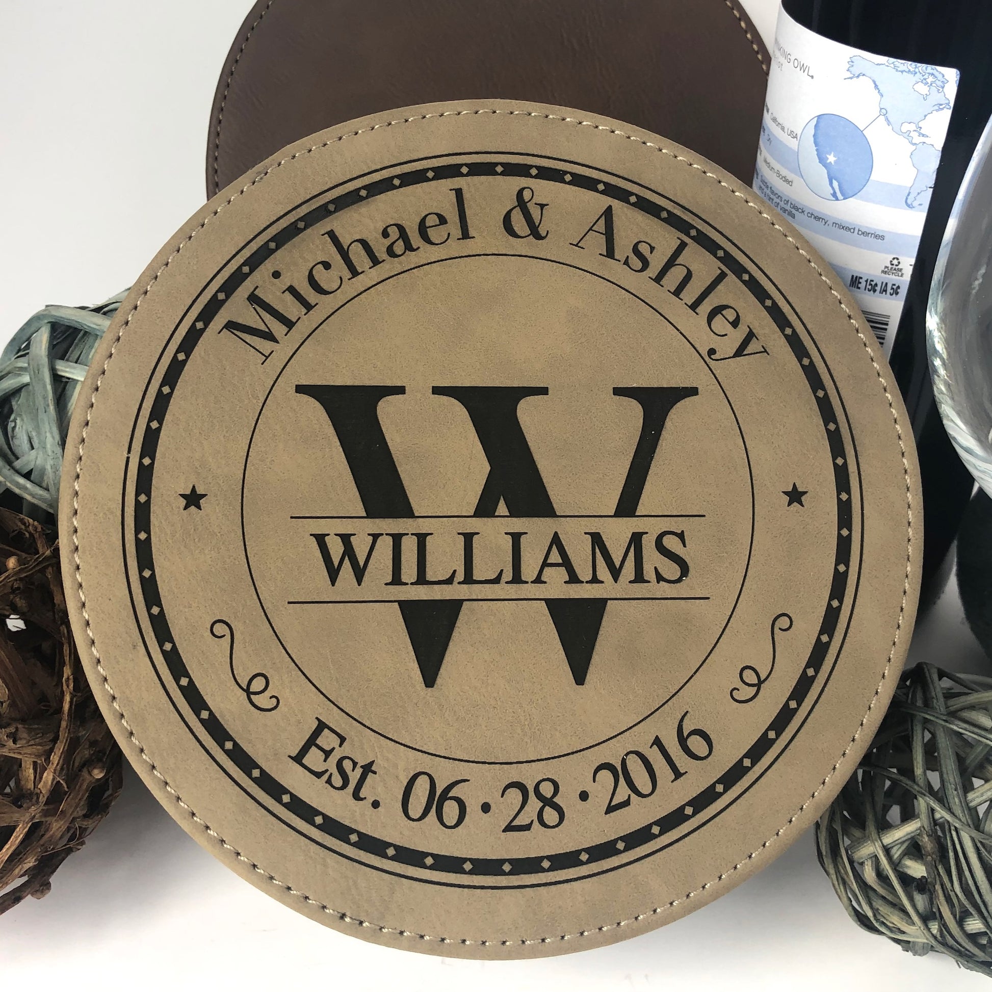 Leather 6 3/4 inch round wine bottle opening set. Choose from one of our stylish designs. The Monogram stamp design (as shown) is classic and can be personalized with initial, surname, couples first names and wedding or special date.