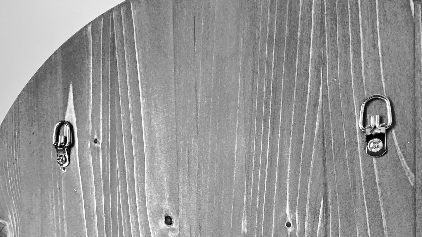 Back view of sign with 2 D-rings attached for easy hanging on the wall.