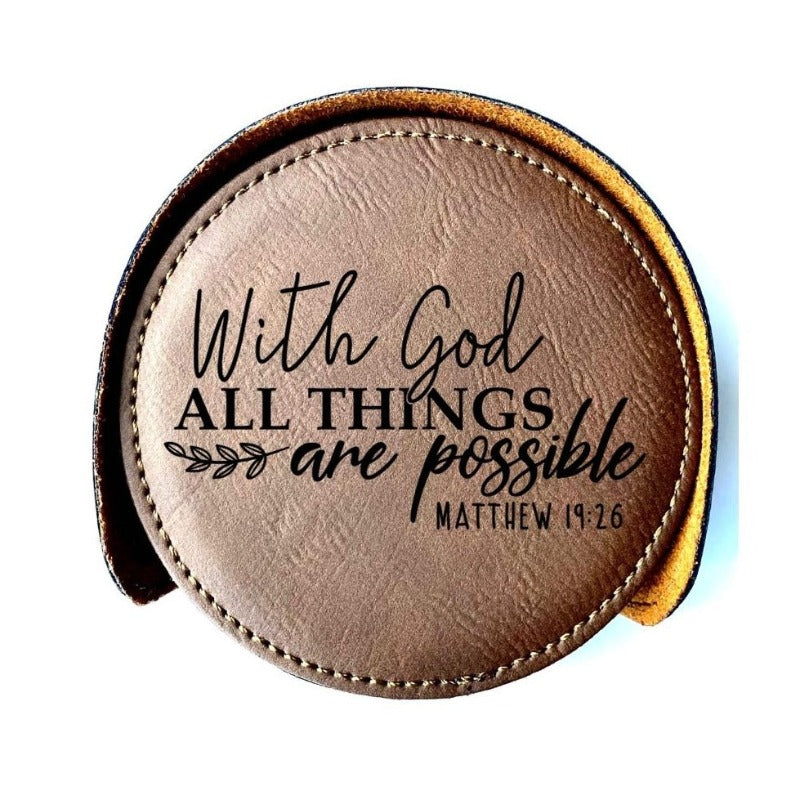 Close up view of one of the 6 round faux leather Bay Brown Inspirational coasters.