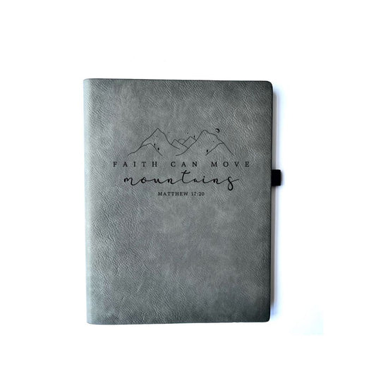 Iron Gray Faux leather journal with "Faith Can Move Mountains Matthew 17:20" engraved on it. Can be personalized with your name or business logo in the bottom right corner. Iron Gray journals do not have a matching pen option.