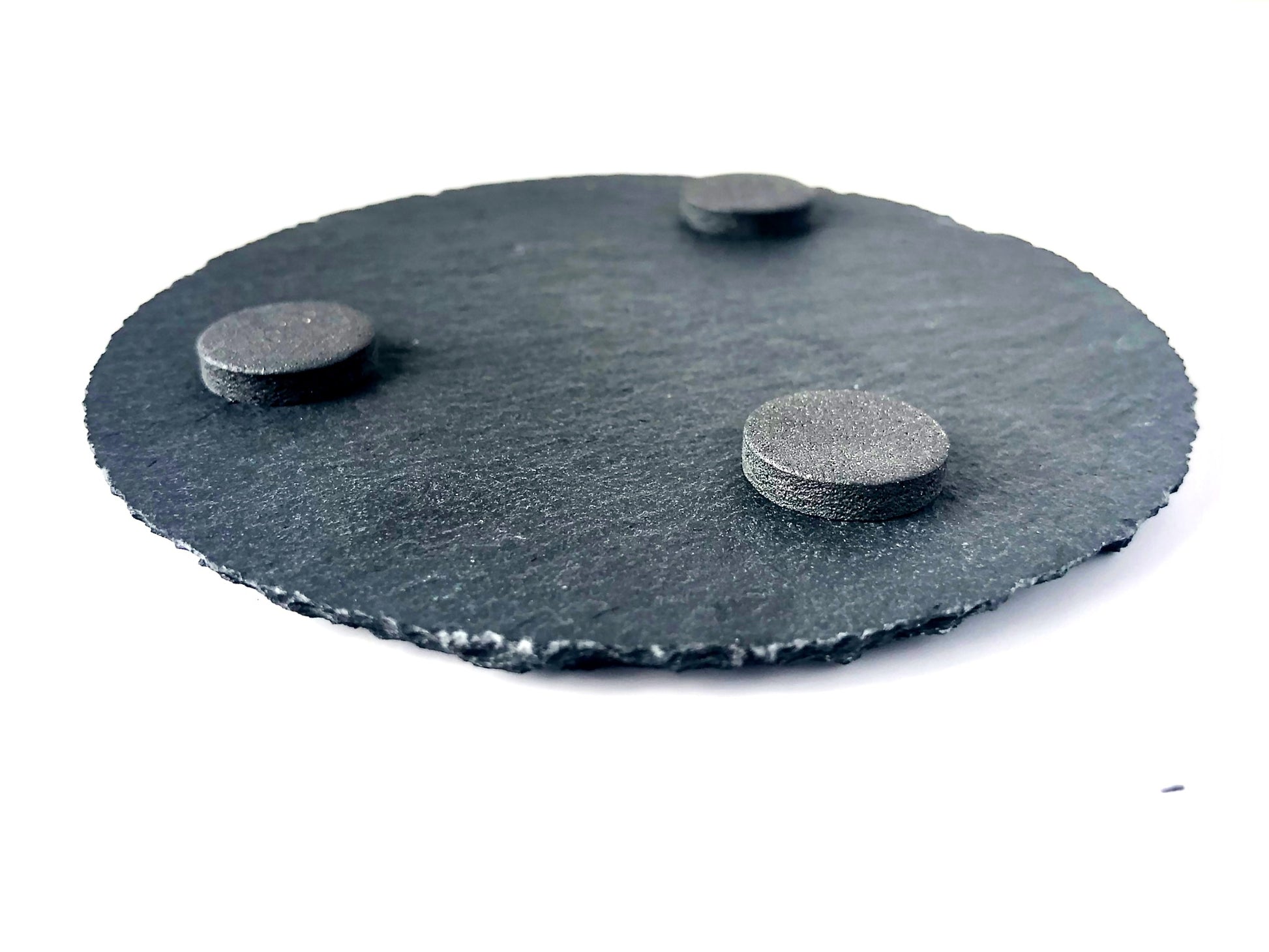 Image of the back of the round slate coaster with 3 felt pads permanently placed to keep your furniture scratch free. 